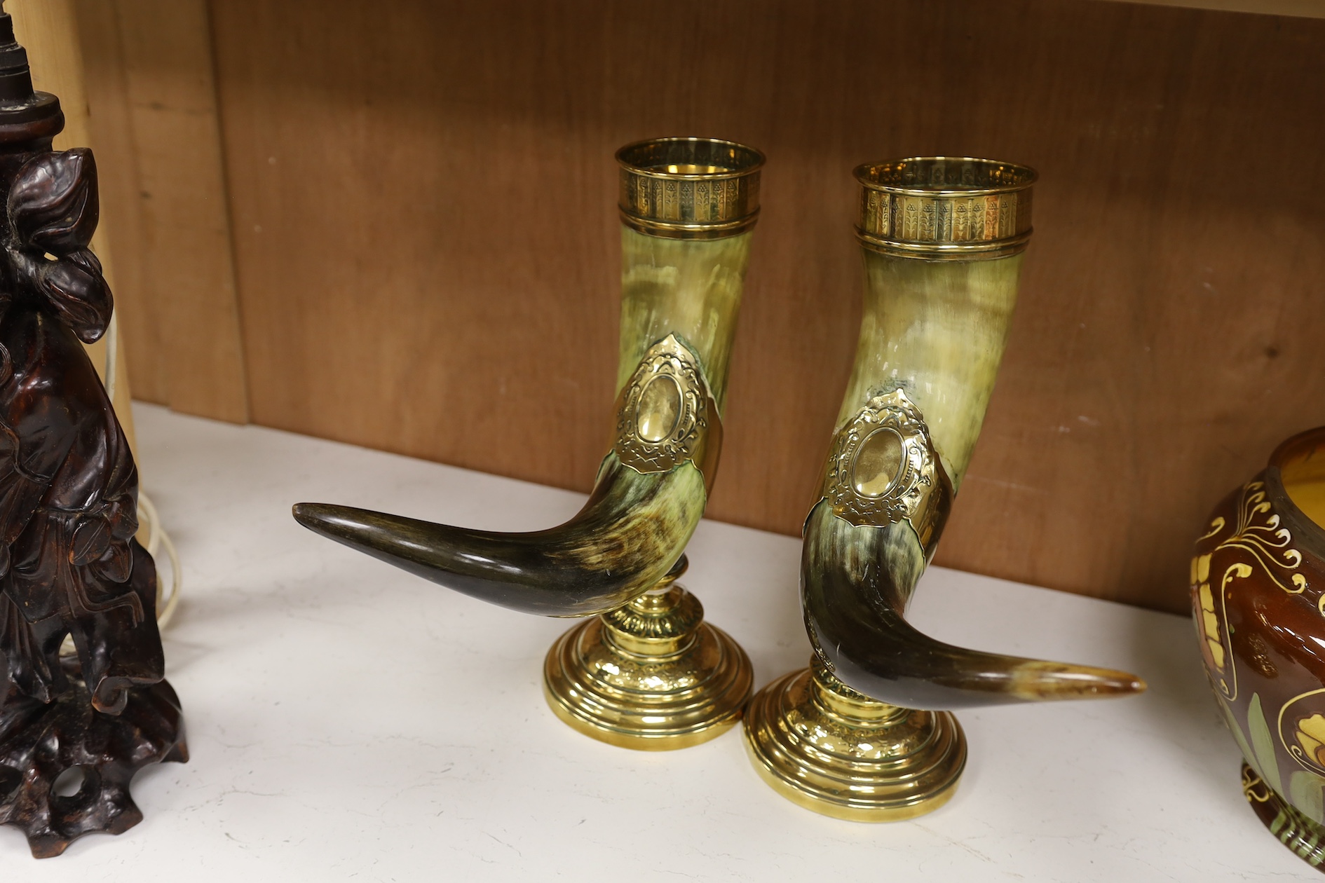 A pair of large decorative brass mounted horns, 33cm high. Condition - brass mounts dented and horns scratched in places